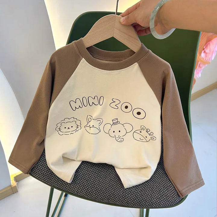 Children's sweatshirt with 'MINI ZOO' text and animal illustrations on a hanger.
